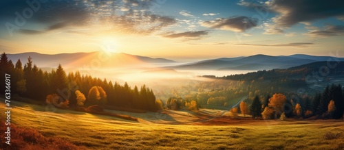 Sunset over mountain valley with autumn trees