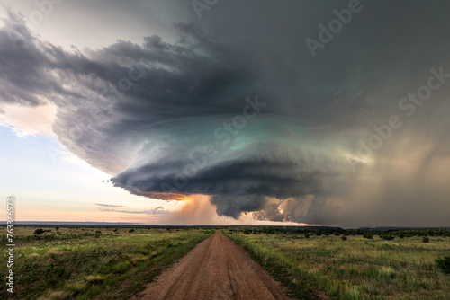 Dirt road leading to supercell storm clouds © JSirlin