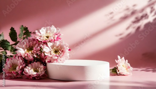 Round podium platform stand for beauty product presentation and beautiful flowers on pink background. with shadows