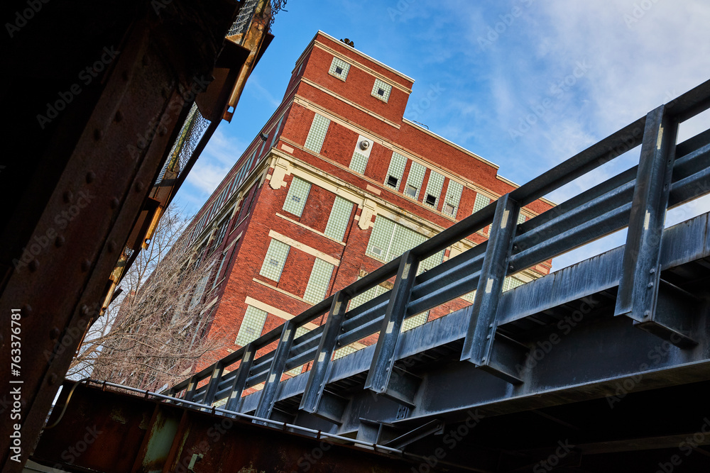 Industrial Bridge and Historic Red Brick Building, Low Angle View