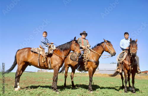 Rancher, his son and grandson on horseback; Howes, South Dakota, United States of America photo