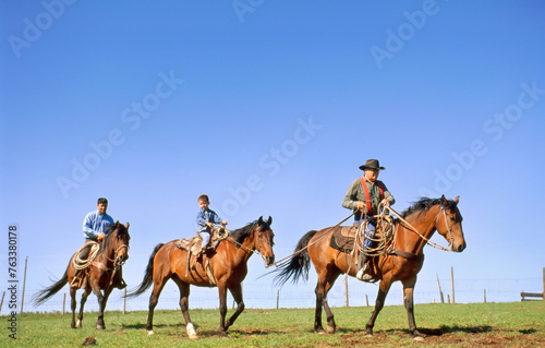 Rancher, his son and grandson on horseback; Howes, South Dakota, United States of America photo