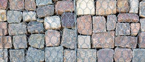 Stone wall, gabion revetment - protection from backshore erosion. Square photo. photo