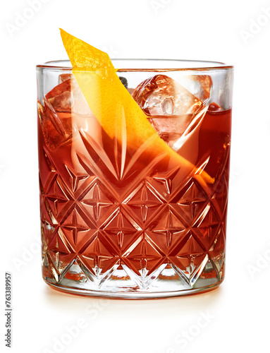 Classic Negroni cocktail garnished with orange peel isolated on white background.