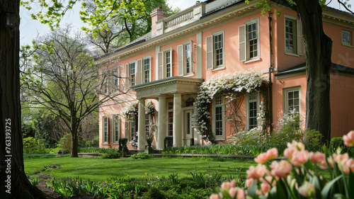 The tranquil exterior of a colonial mansion in Shaker Heights, straight angle, with a soft peach facade and cream dormers, set against the lush greenery of early spring © Nairobi 