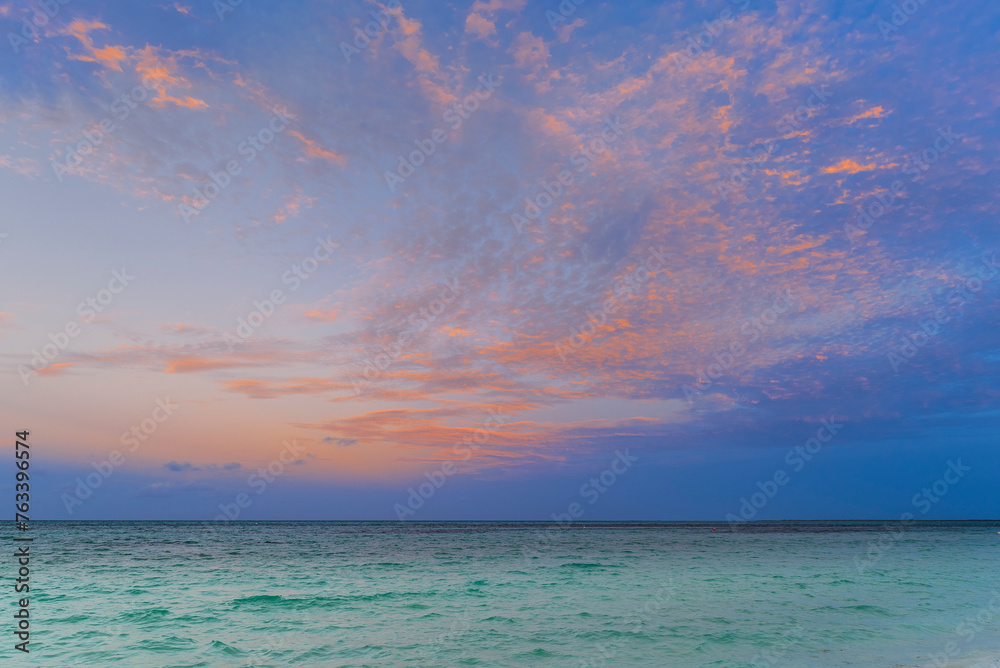 Beautiful sunset sky with glowing clouds over the Caribbean Sea; Cayo Guillermo, Cuba Beautiful sunset sky with glowing clouds over the Caribbean Sea; Cayo Guillermo, Cuba