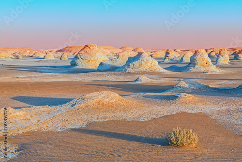 Sand and white limestone formations at sunset in a sea of sand, with shadows in evening light, White Desert Protected Area; Egypt photo