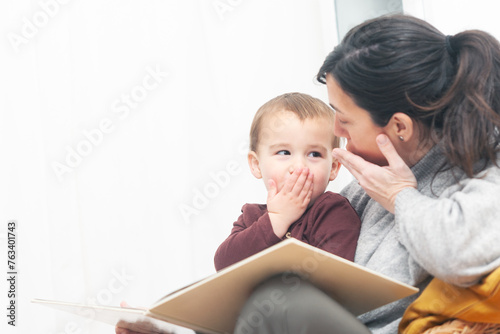 Mother and child interact with gestures during story time.