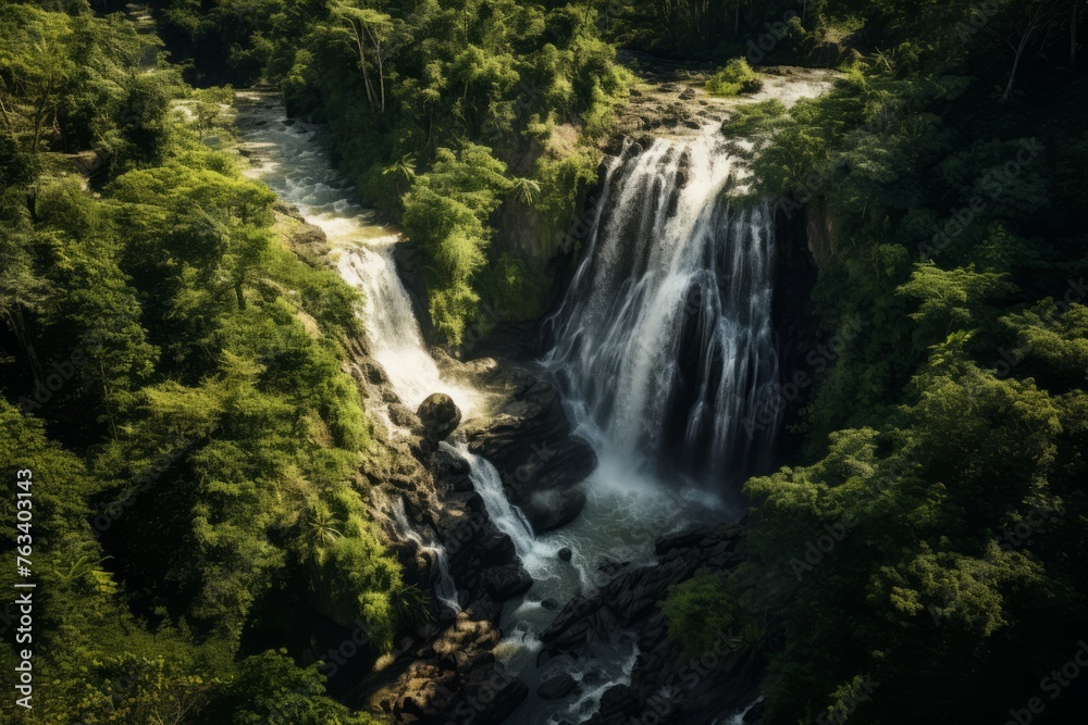 Aerial perspective of a picturesque waterfall hidden in a dense forest Aerial perspective of a picturesque waterfall hidden in a dense forest
