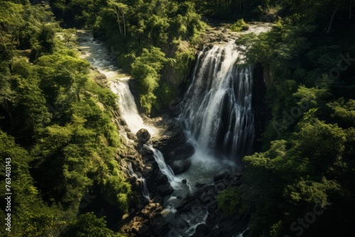 Aerial perspective of a picturesque waterfall hidden in a dense forest © KerXing