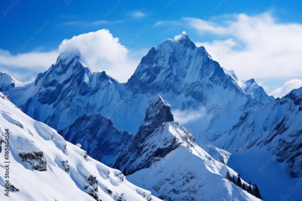 Snow-covered mountain peaks under a clear blue sky background