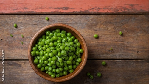 A vibrant bowl of fresh green peas sits on a red wooden background suggesting health and vitality © ArtistiKa