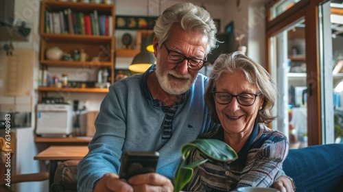 Senior couple using phones to comunicate photo