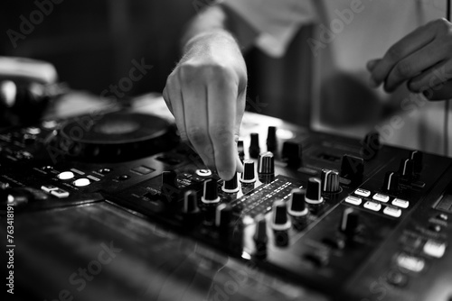 Unsaturated photo of a DJ using turntable in a disco