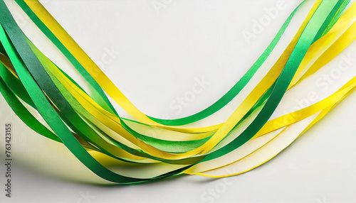 Várias serpentinas na cor verde e amarela com fundo branco e espaço para texto. photo