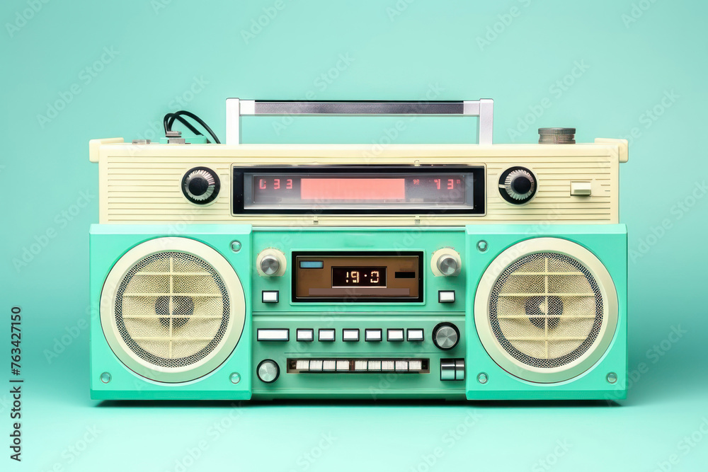 Obraz premium Retro outdated portable stereo boombox radio cassette recorder from 80s front turquoise background