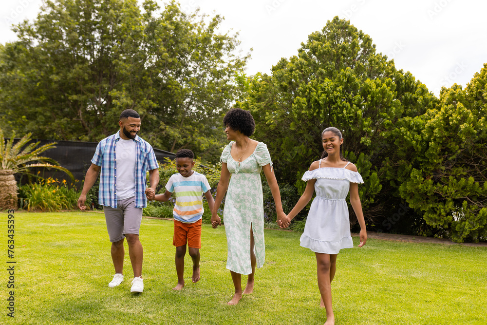 An African American family enjoys a walk in the garden An African American family enjoys a walk in the garden