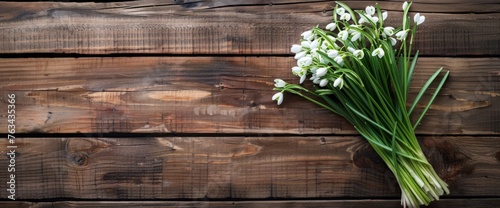 A cluster of vibrant flowers arranged neatly on a rustic wooden table