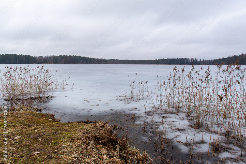 Frozen Katvari lake on a cloudy day in March in Katvari in Latvia