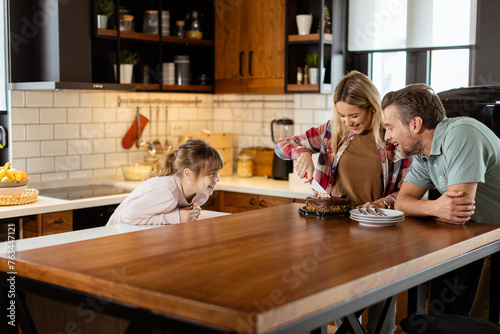 Joyful Family Enjoying Homemade Chocolate Cake in Cozy Kitchen