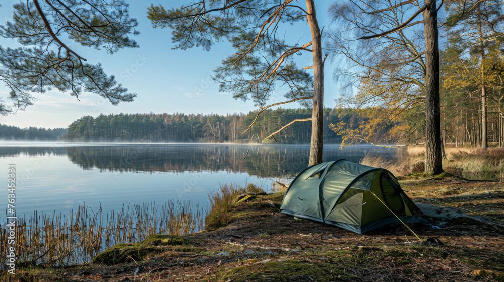 Tent at lakeside campsite. Spring morning. Outdoor adventures. Camping. Traveling.