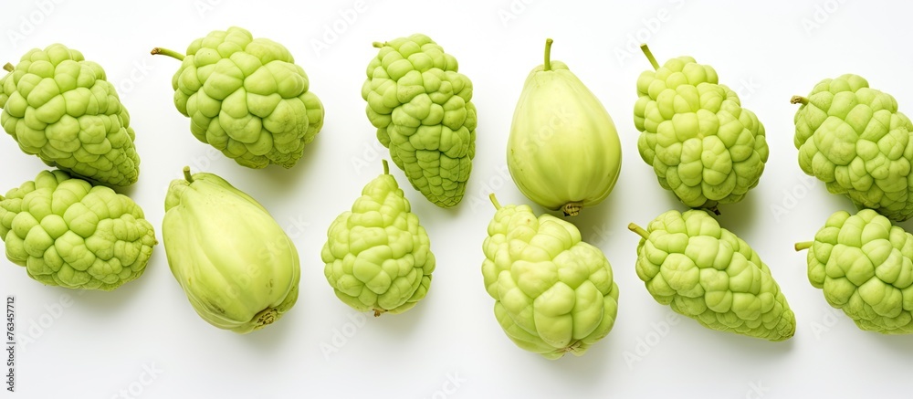 Fototapeta premium Group of green fruits on white surface