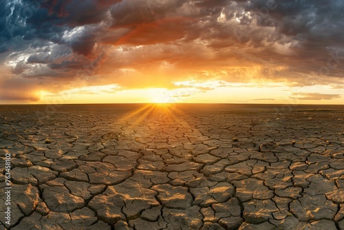 panoramic photo of a breathtaking sunrise over a barren sandy dry falt land