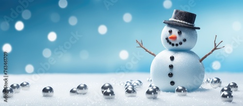 Snowman standing in snow made of screws and nuts on light blue surface © Ilgun