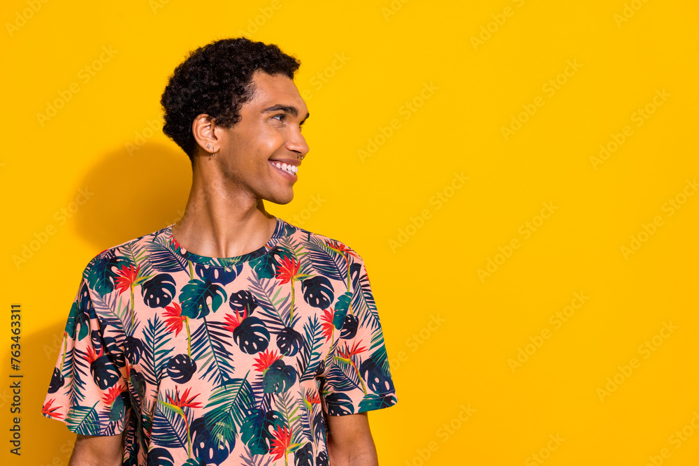 Side profile photo of happy guy in t shirt with piercing and earrings posing like barbershop model isolated on yellow color background Side profile photo of happy guy in t shirt with piercing and earrings posing like barbershop model isolated on yellow color background