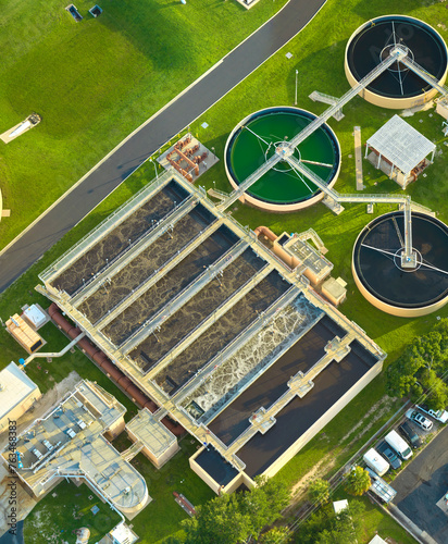 Aerial view of modern water cleaning facility at urban wastewater treatment plant. Purification process of removing undesirable chemicals, suspended solids and gases from contaminated liquid © bilanol