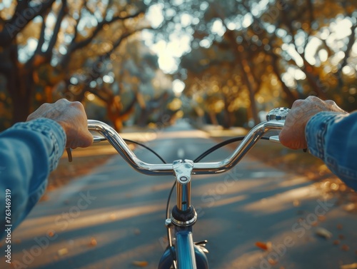 Person Cycling Down Tree-Lined Road