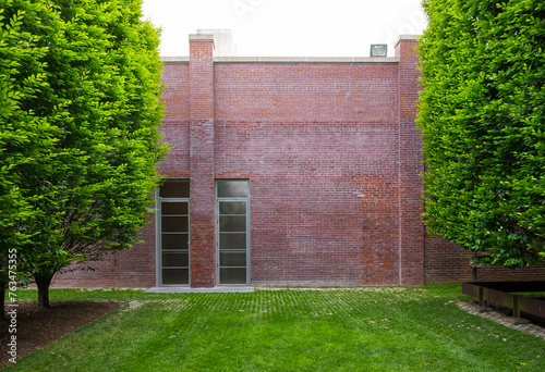 red brick building with tall trees