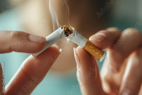 Closeup woman hand destroying cigarette stop smoking concept photo