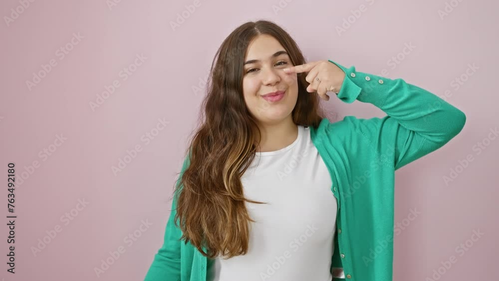 Happy young hispanic woman pointing playfully at her nose – a beautiful smile blooming over her clear, healthy skin isolated against a vibrant pink background, embracing natural beauty Happy young hispanic woman pointing playfully at her nose – a beautiful smile blooming over her clear, healthy skin isolated against a vibrant pink background, embracing natural beauty