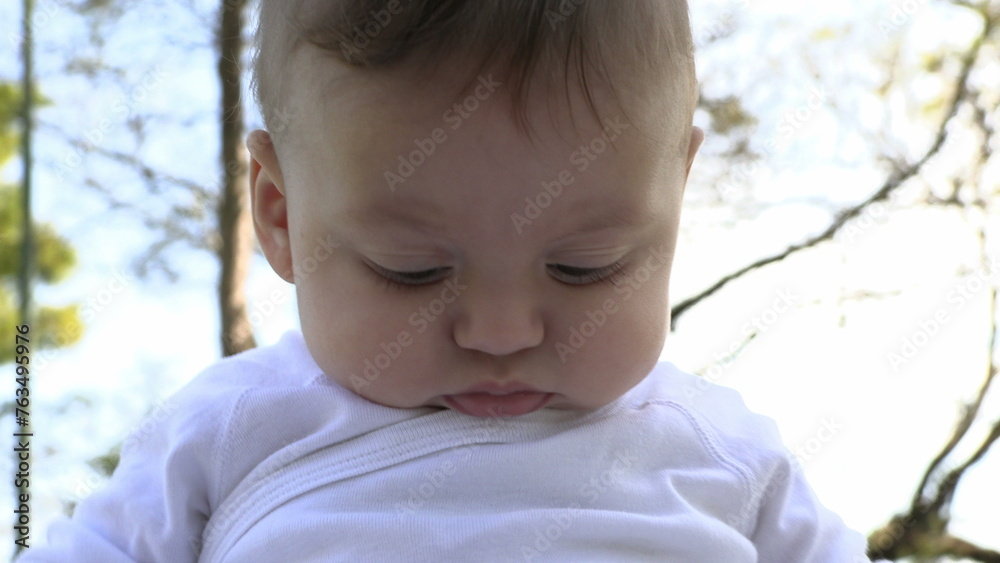 Portrait baby boy toddler infant child discovering observing the world outside park Portrait baby boy toddler infant child discovering observing the world outside park