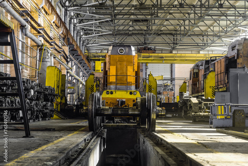 Traction locomotives being serviced at a repair depot. Locomotive on fixed jacking units.