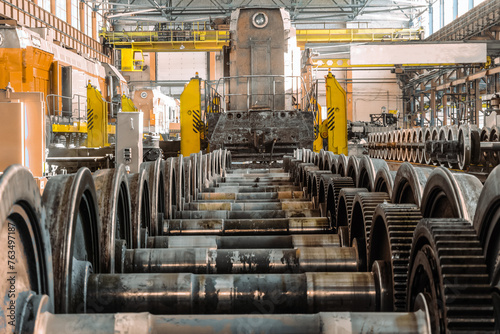 Row of steel wagon train wheels in front of the locomotive. Repair depot. Wheels of train in service.