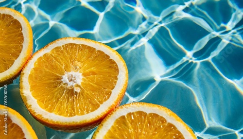 creative summer background with orange fruit slices in swimming pool water summer wallpaper with copy space