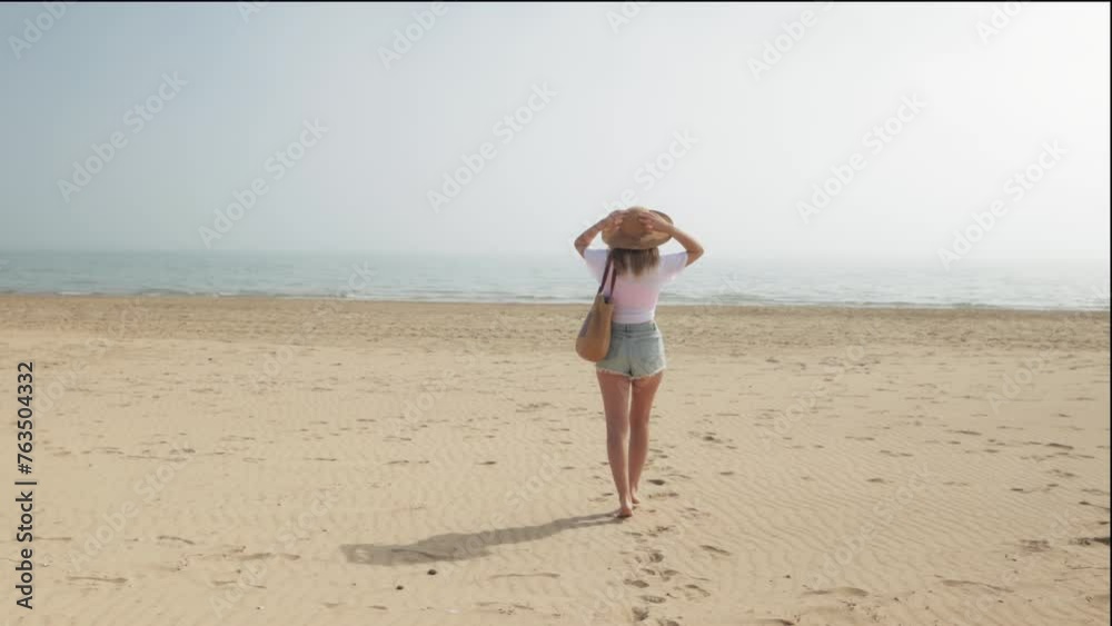 Happy girl walk along beach, embrace warm sun and gentle breeze, embody essence summer relaxation and joyous moments by sea. Happy girl walk along beach, embrace warm sun and gentle breeze, embody essence summer relaxation and joyous moments by sea.