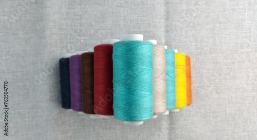 Rolls of multi-colored threads for tailors working in the garment embroidery sector