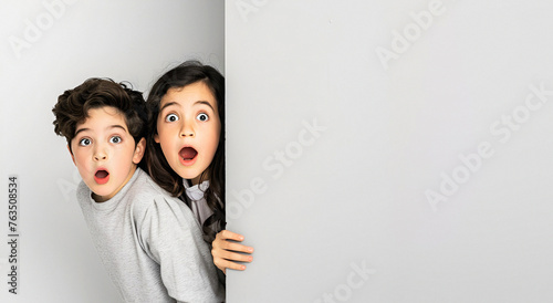 Two children looking out of the wall