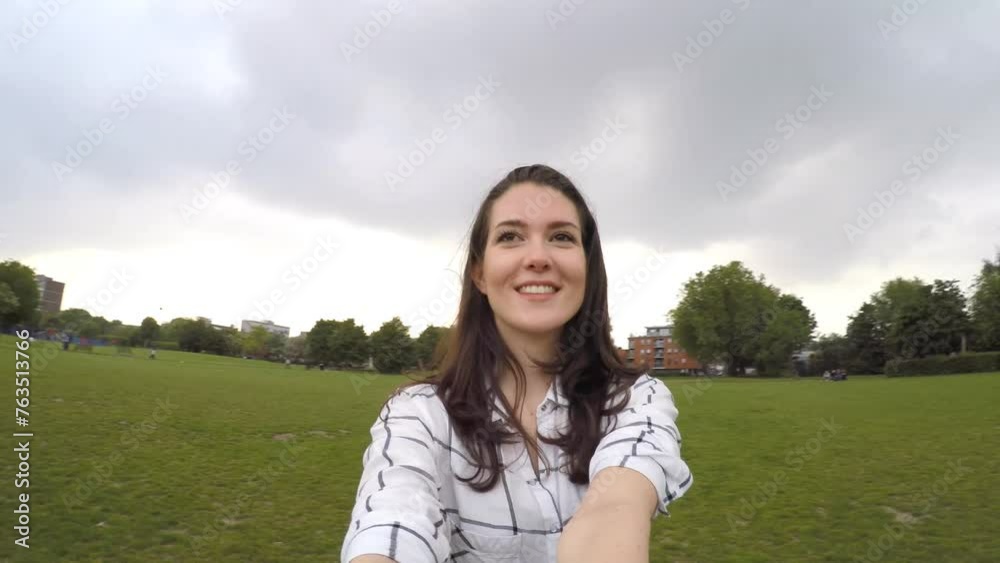 Young woman relaxing and walking at park on a cloudy day in London Young woman relaxing and walking at park on a cloudy day in London