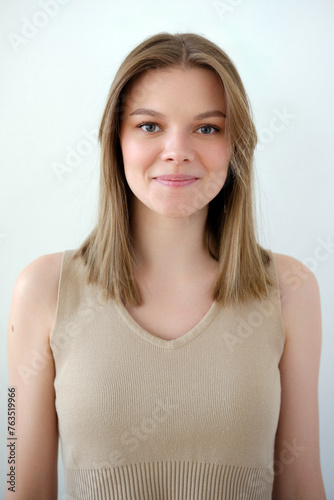 Young girl model snap in beige top t-shirt front look portrait view on white background