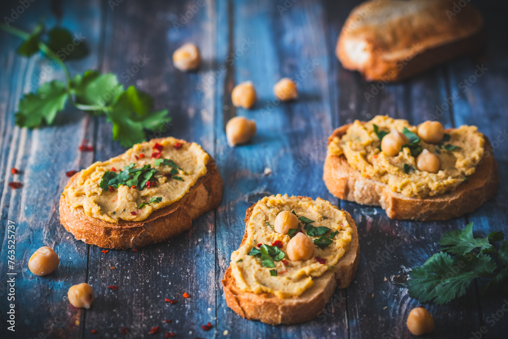 Toasted bread slices with hummus, chickpea puree