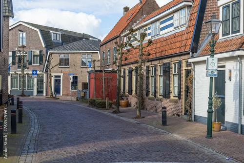 street iSpakenburg, the Netherlands. 25 February 2024. A street with typical houses in Spakenburg. The village has several harborsn the town © PixelBiss