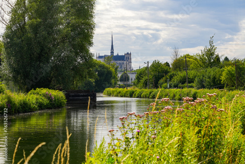 View of the Cathedral of Amiens from the banks of the River Somme in the famous Hortillonnages of Amiens in Picardy, France