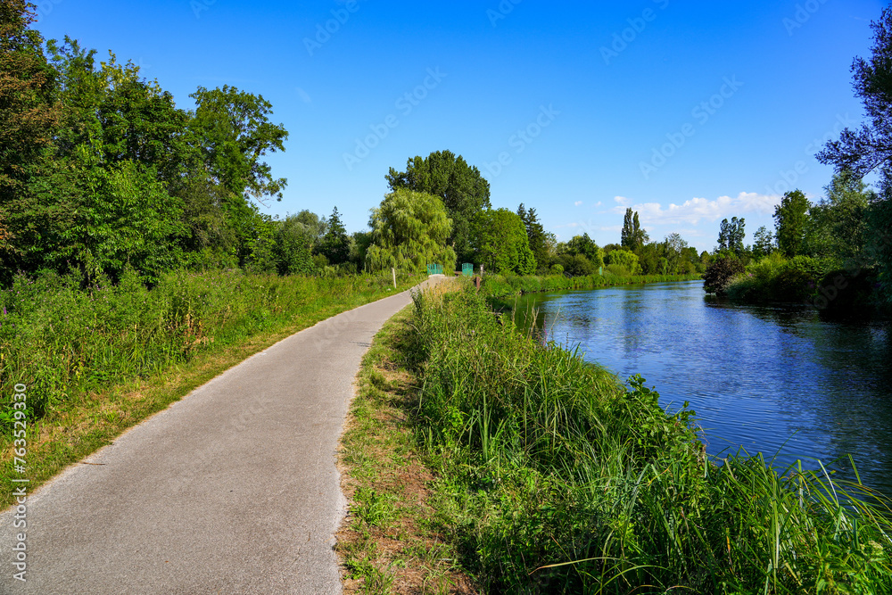 Towpath along the banks of the River Somme in the famous Hortillonnages of Amiens in Picardy, France Towpath along the banks of the River Somme in the famous Hortillonnages of Amiens in Picardy, France