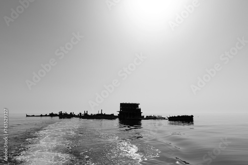 A back lit image of a  submerged tugboat shipwreck around 8km in the eastern Bahrain sea.