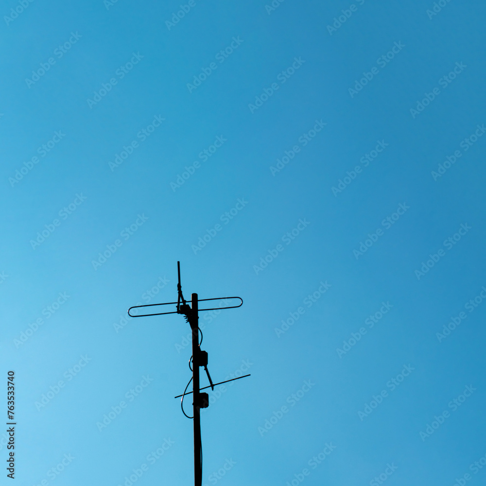 Antenna on blue sky creative copy space concept of telecommunications and technology. Antenna on blue sky creative copy space concept of telecommunications and technology.