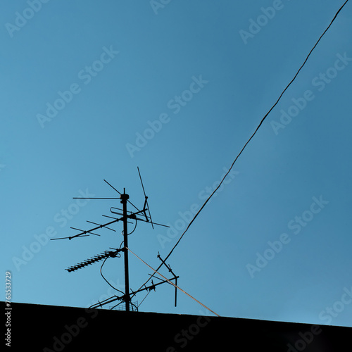 Antenna on blue sky creative copy space concept of telecommunications and technology. 